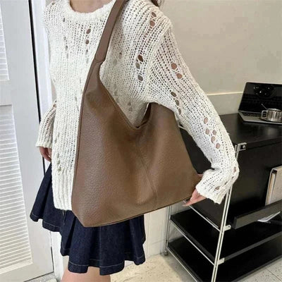 Trendy leather tote bag with spacious design and sturdy handles.