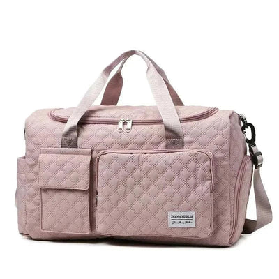 Fashion travel bag large capacity in pink canvas with multiple compartments and adjustable strap.