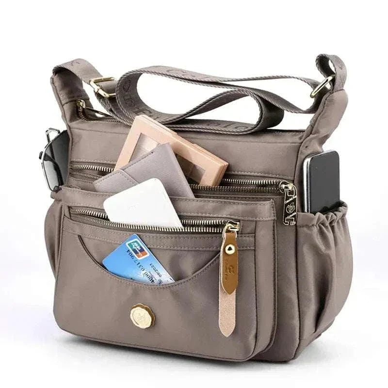 Luxury women pouch Dino in PU leather with spacious interior and detachable wrist strap.