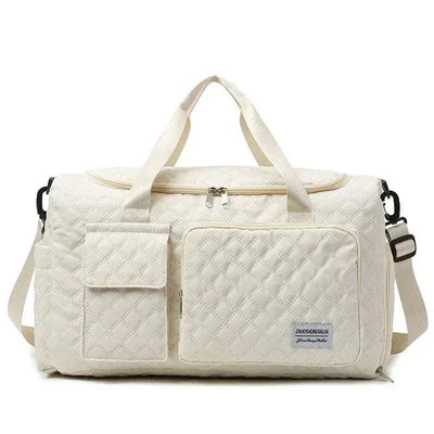 Fashion travel bag large capacity in cream canvas with multiple compartments and sturdy handles.